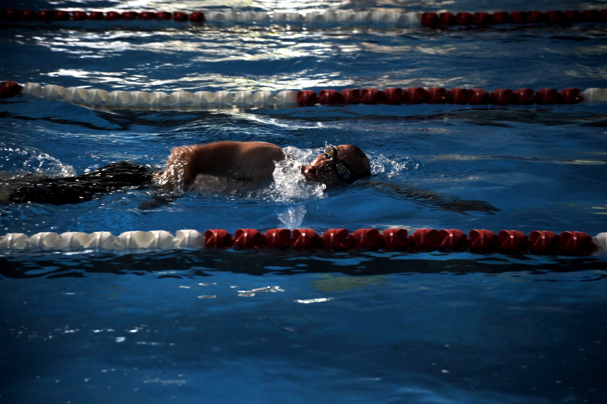 A participant swims during the second annual triathlon July 7 at Mountain Home Air Force Base, Idaho. The event, which was hosted by the base fitness center, consisted of three events - a 400-meter (.25 mile) swim, a 20-kilometer (12.4 miles) bike portion, and a 5-kilometer (3.1 miles) run. Participants competed individually or in three-person teams. (U.S. Air Force photo/Senior Airman Benjamin Sutton)