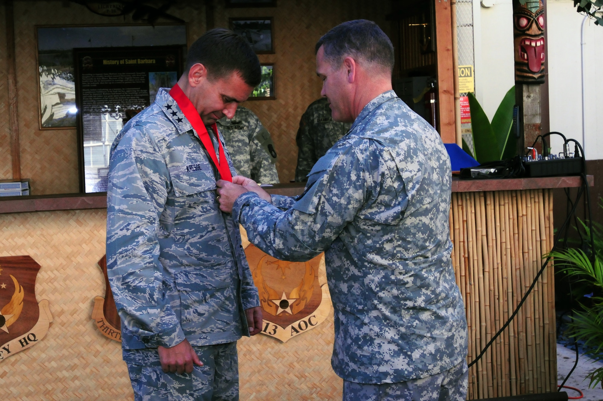 Lt. Gen. Ted Kresge (left), Commander, 13th Air Force, is inducted into the Order of Saint Barbara military honor society and presented a member’s only medal and certificate by U.S. Army Brig. Gen. James Dickenson, commanding general, 94th Army Air & Missile Defense Command, on July 2 2012, at Joint Base Pearl Harbor-Hickam, Hawaii. The award recognizes officers, Soldiers, and citizens who have demonstrated an outstanding degree of excellence and dedication to the advancement of artilleries. Dickenson, on behalf of more than 40 Soldiers from the 5th Battalion Command Division who work alongside Airmen in the 613th Air and Space Operations Center, thanked Kresge for his relentless support for the Soldiers working in AOC and making them a part of the team. (U.S. Air Force photo/ Master Sgt. Kerry Jackson) 