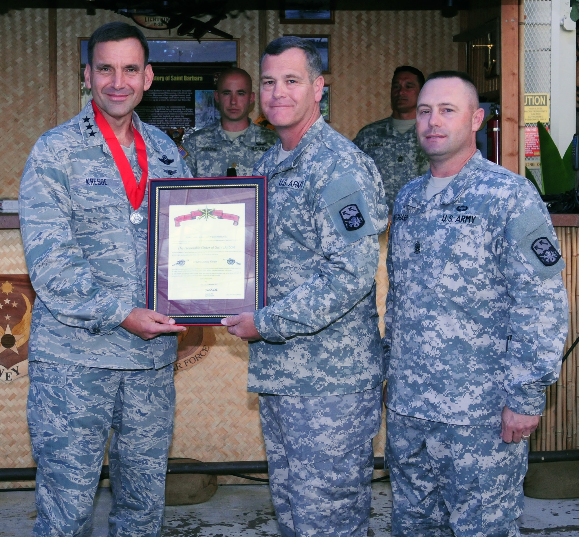 Lt. Gen. Ted Kresge (left), Commander, 13th Air Force, is inducted into the Order of Saint Barbara military honor society and presented a member’s only medal and certificate by U.S. Army Brig. Gen. James Dickenson, commanding general, 94th Army Air & Missile Defense Command, on July 2 2012, at Joint Base Pearl Harbor-Hickam, Hawaii. The award recognizes officers, Soldiers, and citizens who have demonstrated an outstanding degree of excellence and dedication to the advancement of artilleries. Dickenson, on behalf of more than 40 Soldiers from the 5th Battalion Command Division who work alongside Airmen in the 613th Air and Space Operations Center, thanked Kresge for his relentless support for the Soldiers working in AOC and making them a part of the team. (U.S. Air Force photo/ Master Sgt. Kerry Jackson) 