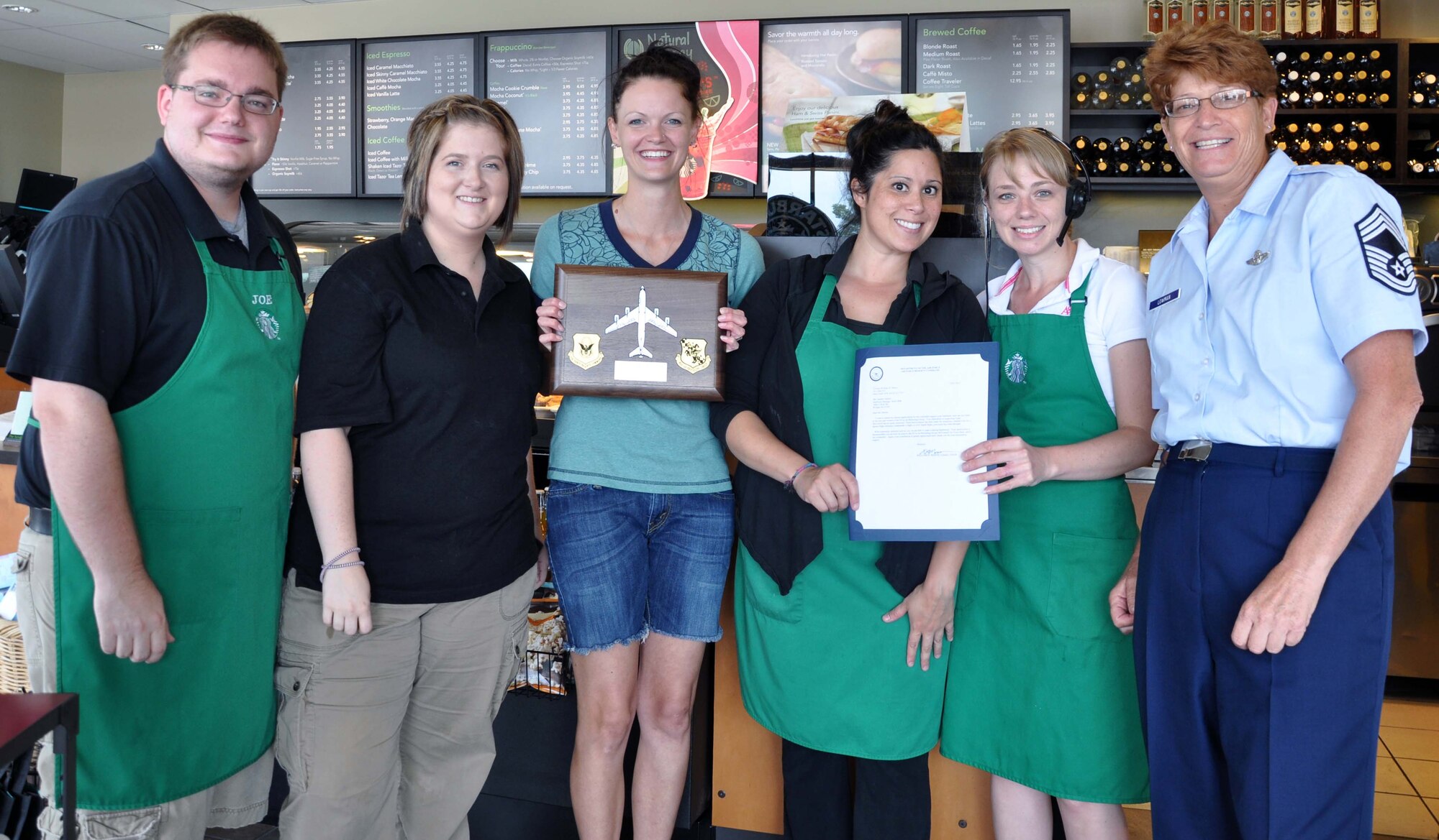 Chief Master Sgt. Kathleen E. Lowman, acting group superintendent of the 931st Air Refueling Group, McConnell Air Force Base, Kan., presents a plaque and letter of appreciation to employees of Starbucks store #2898 in Wichita, July 9, 2012.  The coffee establishment has supported multiple 931st events over the last year. (U.S. Air Force photo by 1st Lt. Zach Anderson)  