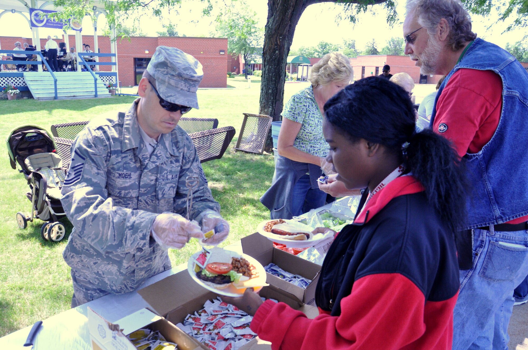 WRIGHT-PATTERSON AIR FORCE BASE, Ohio – Master Sgt. John Koehl, 445th Logistics Readiness Squadron first sergeant, serves food to veterans and staff at the Dayton Veterans Affairs Medical Center annual picnic June 2. (U.S. Air Force photo/Master Sgt. Charlie Miller)