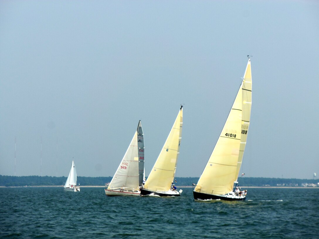 Three sailing yachts cross the starting line for the 2012 Veterans’ Cup sailboat race on the Chesapeake Bay July 7, 2012. Proceeds from the race were donated to the Virginia Wounded Warrior Program. (U.S. Air Force photo by Tech. Sgt. Randy Redman / Released)