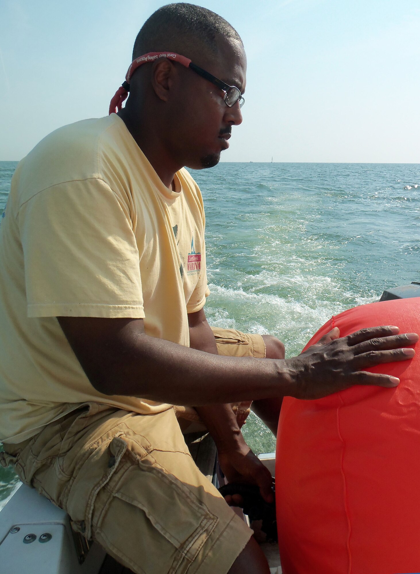 Jonathan Romero, Langley Yacht Club member, inflates one of the markers for the 2012 Veterans’ Cup sailboat race July 7, 2012. Proceeds from the race were donated to the Virginia Wounded Warrior Program. (U.S. Air Force photo by Tech. Sgt. Randy Redman / Released)