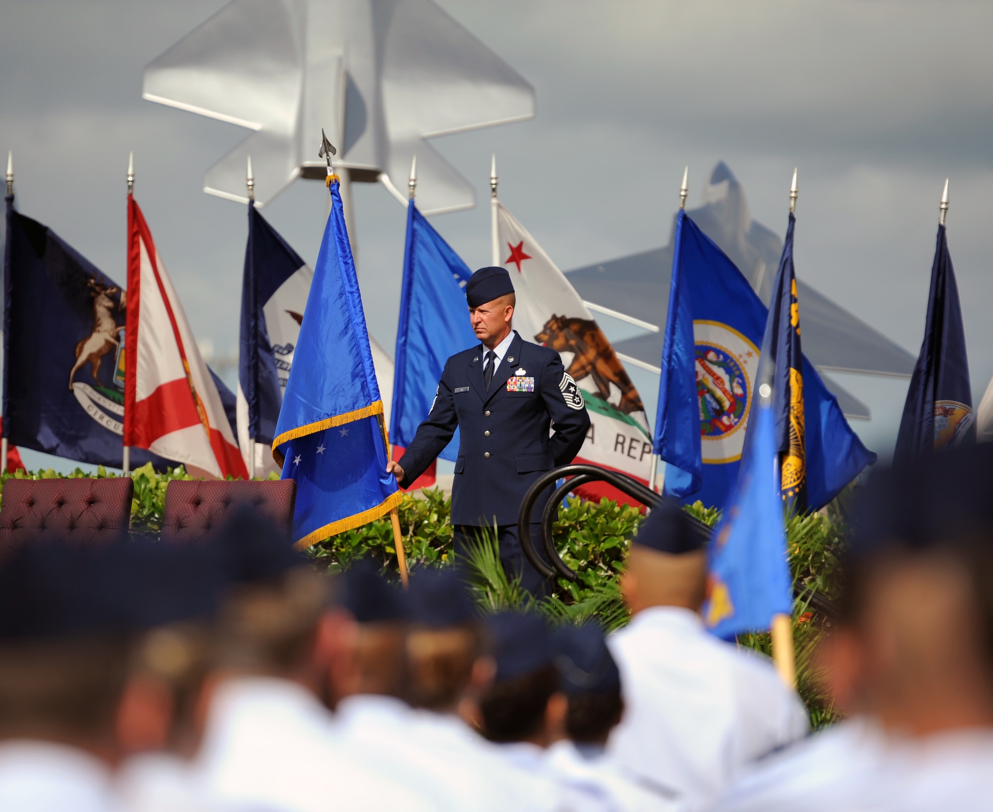 Chief Master Sgt. Robert Rodewald, 15th Wing command chief, holds the 15th WG guidon before the start of the 15th Wing Change of Command ceremony July 6 at Joint Base Pearl Harbor-Hickam, Hawaii. During the ceremony, command of the 15th WG passed from Col. Sam Barrett to Col. Johnny Roscoe. (U.S. Air Force photo by Staff Sgt. Nathan Allen)