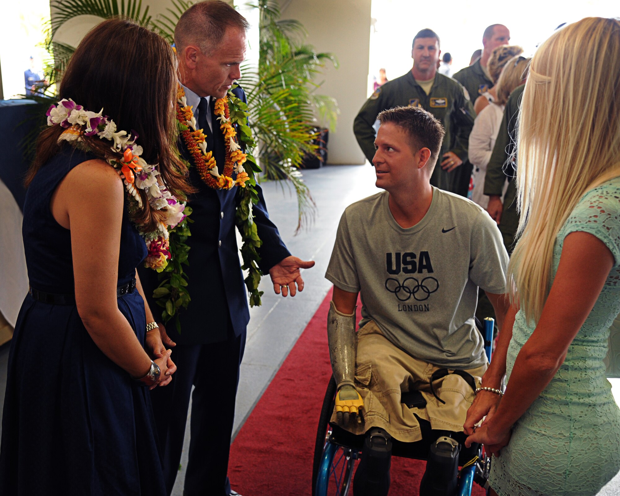 Col. Johnny Roscoe, incoming 15th Wing commander, speaks to Senior Airman (retired) Brian Kolfage and his wife Ashley, following the 15th WG Change of Command ceremony July 6 at Joint Base Pearl Harbor-Hickam, Hawaii. During the ceremony, command of the 15th WG passed from Col. Sam Barrett to Roscoe. (U.S. Air Force photo by Staff Sgt. Nathan Allen)
