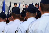 Lt. Gen. Ted Kresge, 13th Air Force commander (left), Col. Sam Barrett (middle), outgoing 15th Wing commander, and Col. Johnny Roscoe (right), incoming 15th WG commander, prepare to begin the ceremony in which Kresge will pass the 15 WG guidon to Roscoe, signifying his assumption of command, July 6 at Joint Base Pearl Harbor-Hickam, Hawaii. (U.S. Air Force photo by Senior Airman Lauren Main)