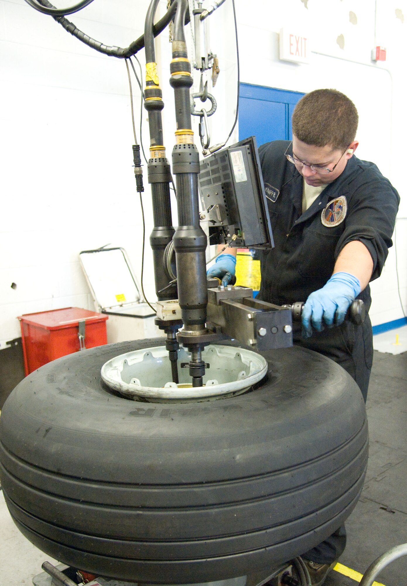 Airman 1st Class Bradley Knapp, a wheel and tire journeyman with the 436th Maintenance Squadron, breaks down a C-5M Super Galaxy nose tire July 9, 2012, at Dover Air Force Base, Del. The inspection rotation on all tires recently dropped 60 days, increasing the workload for the wheel and tire section. (U.S. Air Force photo by Adrian R. Rowan)