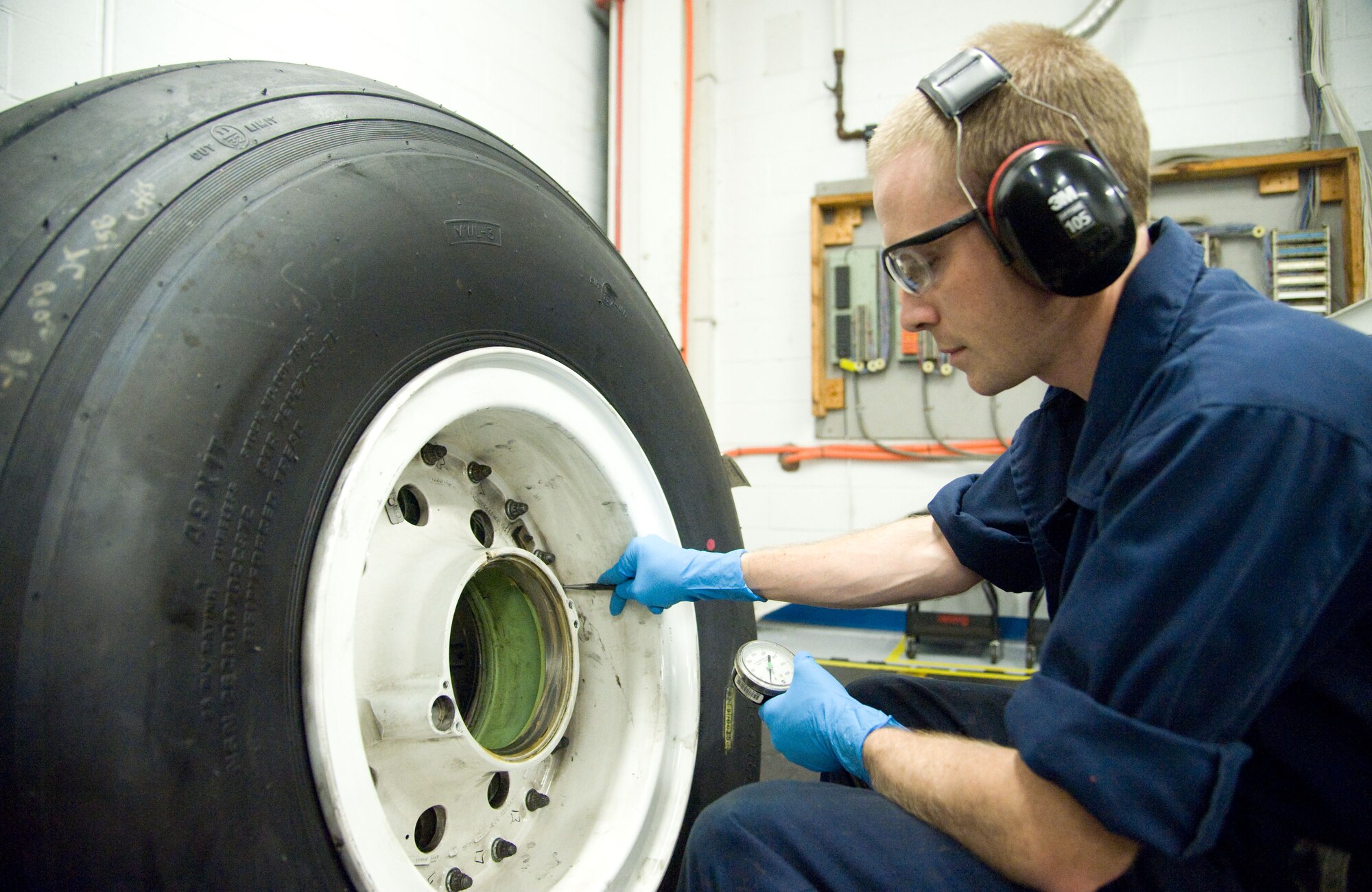 Staff Sgt. Wesley Stair, wheel and tire section chief with the 436th Maintenance Squadron, checks a C-5M Super Galaxy nose tire for leakage July 9, 2012, at Dover Air Force Base, Del. The inspection rotation on all tires recently dropped 60 days, increasing the workload for the wheel and tire section. (U.S. Air Force photo by Adrian R. Rowan)