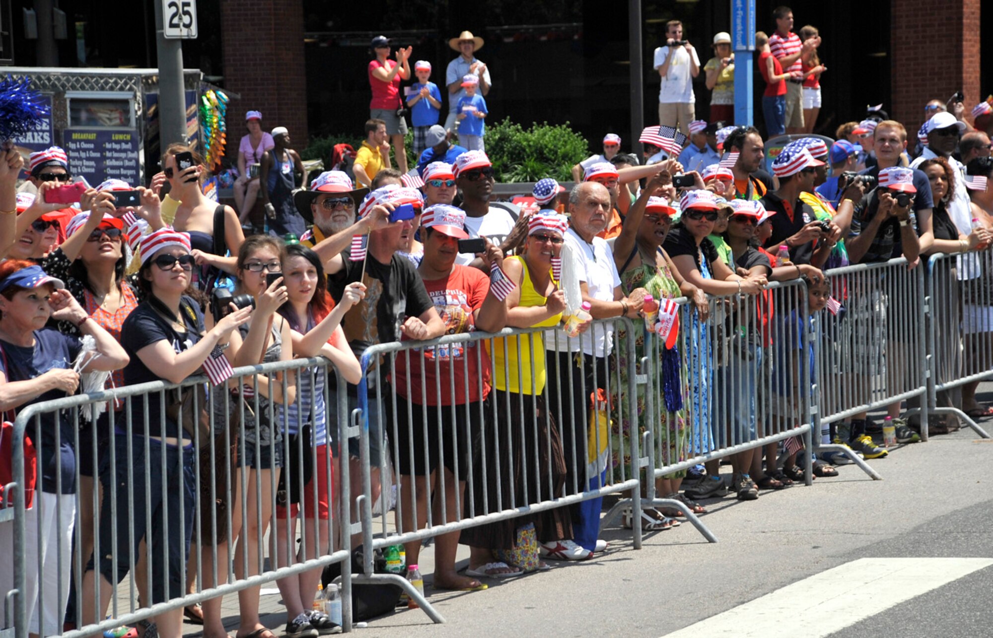 Spectators watch as participants in the Independence Day Parade march by July 4, 2012, in Philadelphia, Pa. 436th Airlift Wing members from Dover Air Force Base, Del., participated in the annual event in Old Town Philadelphia. (U.S. Air Force photo by Tech. Sgt. Chuck Walker)
