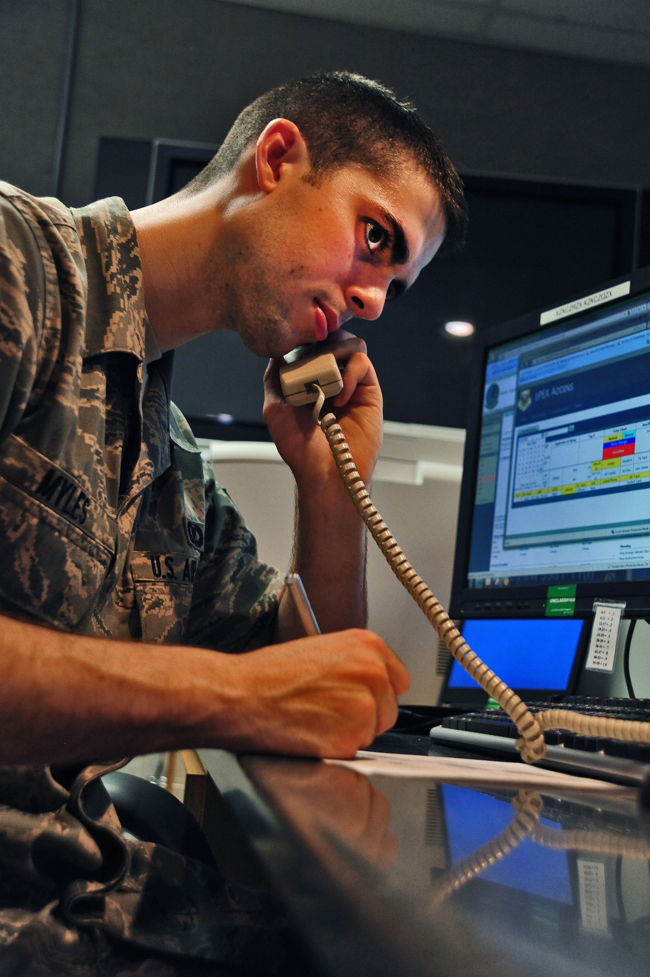 WHITEMAN AIR FORCE BASE, Mo. -- Senior Airman Dennis Myles, 509th Operations Support Squadron airfield management shift lead, coordinates information for flight plans June 30. Pilots contact airfield management about cases ranging from changing their route to responding to in-flight emergencies. Airfield management then takes the appropriate precautions for each issue. (U.S. Air Force photo/Senior Airman Nick Wilson) (Released)