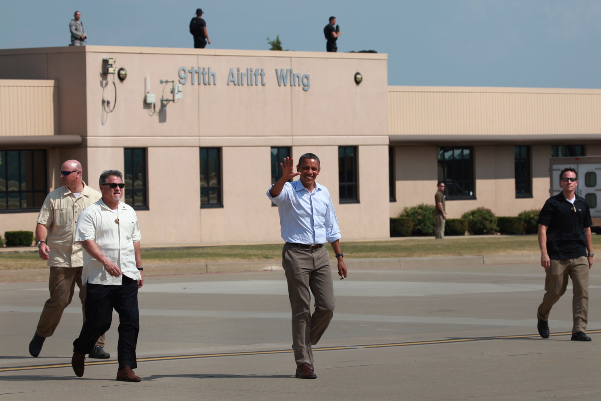 President Barack Obama waves as he walks toward Air Force One at the 911th Airlift Wing, July 06, 2012. The departure from the base was part of the President’s first bus tour of the campaign season, which began with a day of events in Ohio and then concluded the following day at Carnegie Mellon University in Pittsburgh, Pa.   At the base he left behind his campaign bus and boarded Air Force One, which was headed back to Washington D.C. (U.S. Air Force Photo by Tech. Sgt. Ralph Van Houtem/Released)    