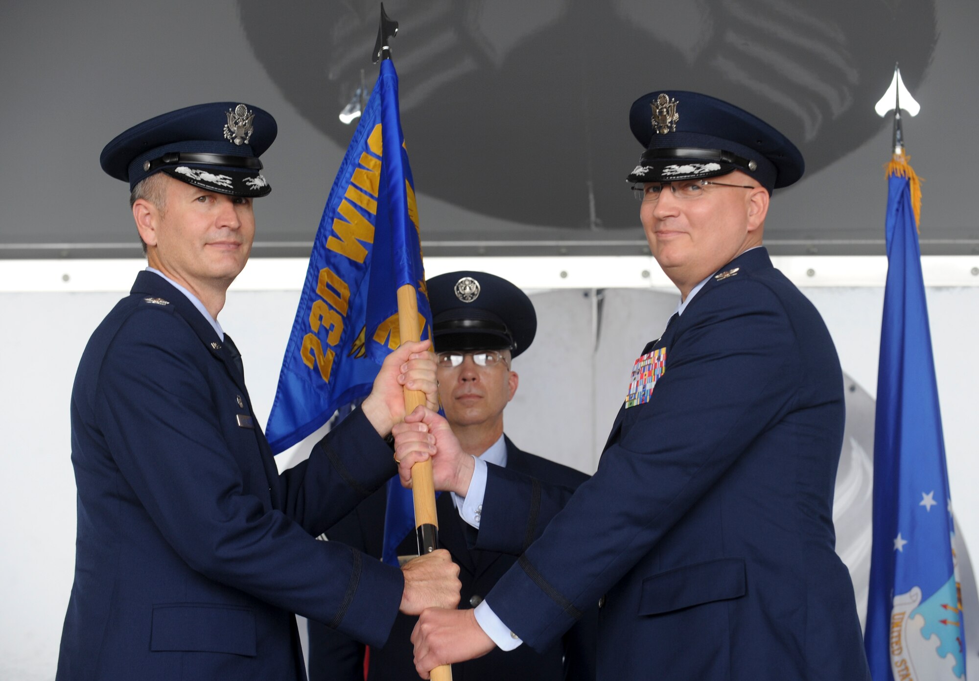 U.S. Air Force Col. Billy Thompson, left, 23d Wing commander, passes the guidon to Col. Jeffrey Decker, incoming 23d Maintenance Group commander, at Moody Air Force Base, Ga., July 6, 2012. The passing of the guidon is symbolic of a new commander taking command of a squadron, group or wing. (U.S. Air Force photo by Airman 1st Class Douglas Ellis/Released)
