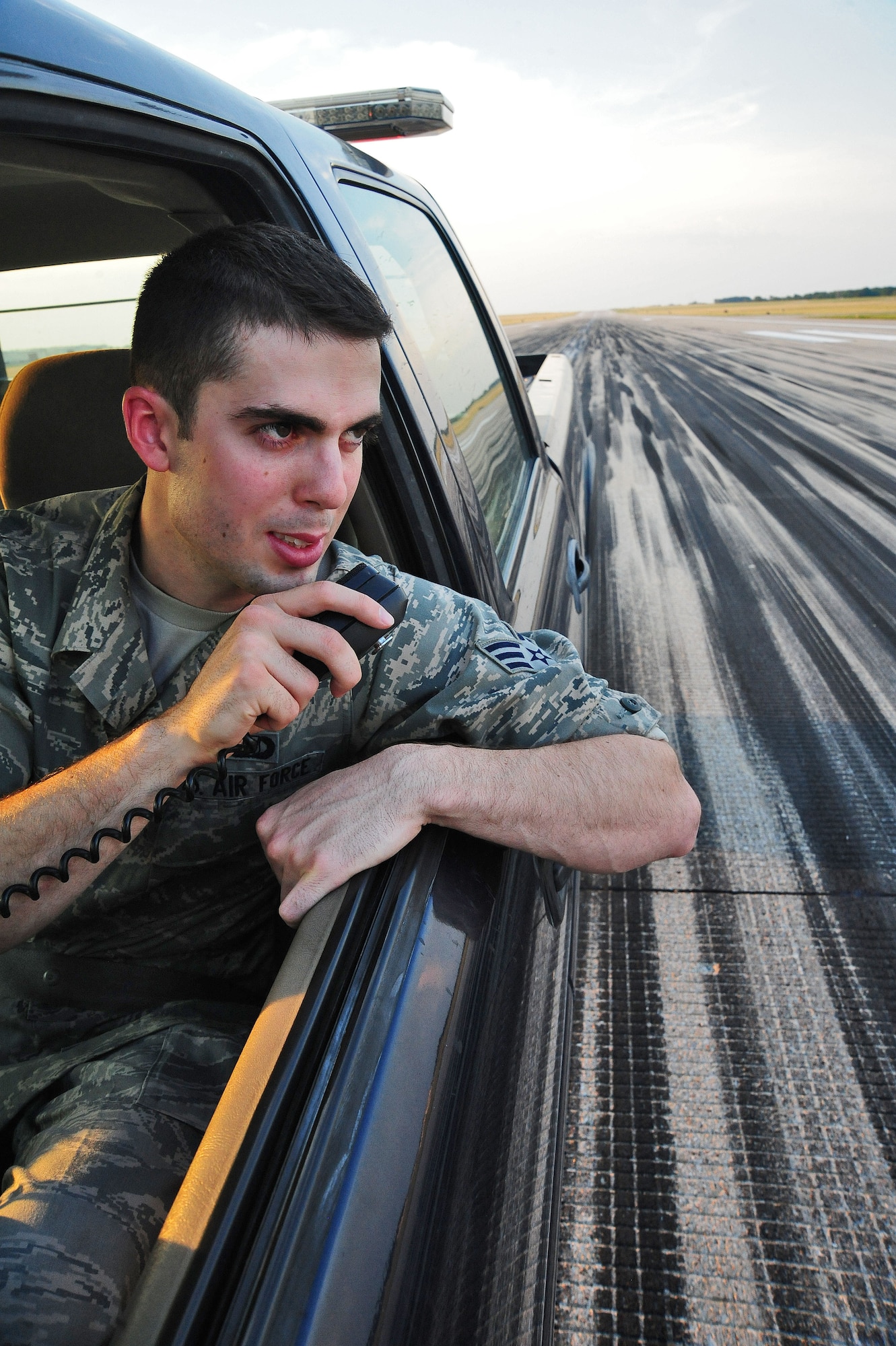 WHITEMAN AIR FORCE BASE, Mo. -- Senior Airman Dennis Myles, 509th Operations Support Squadron airfield management shift lead, alerts the tower of a coyote running across the runway June 30. The Airfield Management team documents wildlife and works closely with the base conservation office to ensure the animals stay off of the runway. (U.S. Air Force photo/Senior Airman Nick Wilson) (Released)
