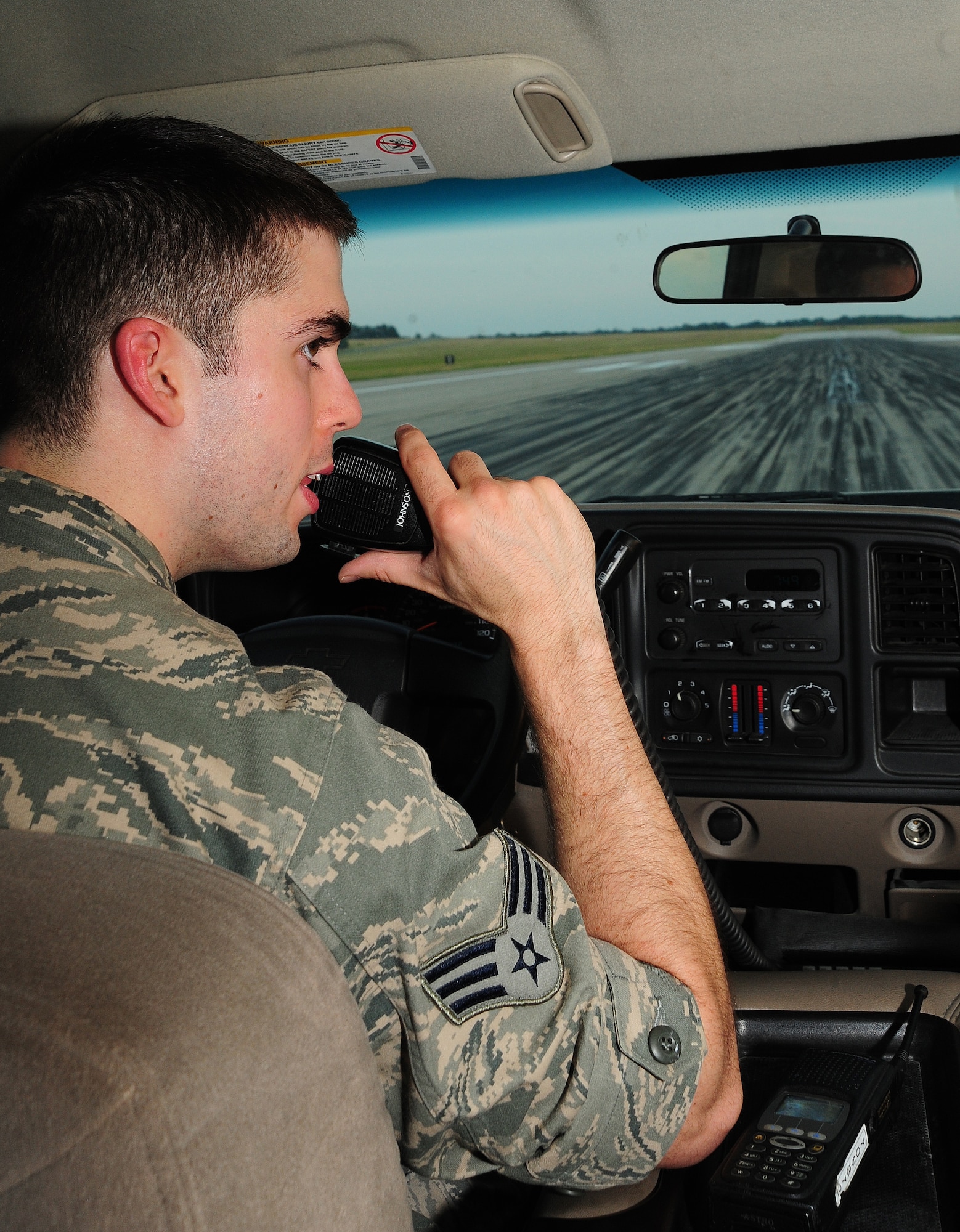 WHITEMAN AIR FORCE BASE, Mo. -- Senior Airman Dennis Myles, 509th Operations Support Squadron airfield management shift lead, coordinates with the air traffic control tower prior to departing  the runway June 30. All vehicle operators must maintain two-way radio contact with the tower when driving on the runway to prevent runway incidents and controlled movement area violations. (U.S. Air Force photo/Senior Airman Nick Wilson) (Released)

