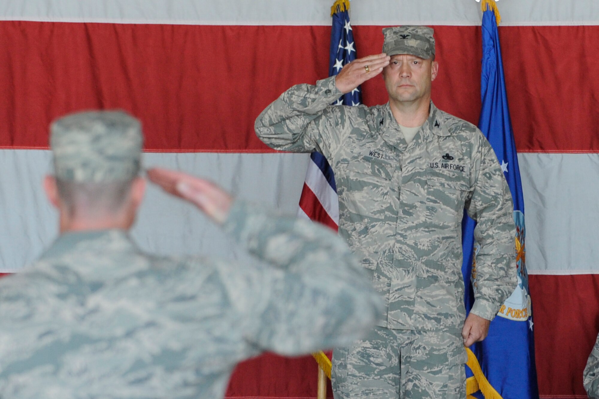 U.S. Air Force Col. Dane West, receives his first salute after taking command of his group during the 388th Maintenance Group change of command ceremony at Hill Air Force Base, Utah, June 29. The ceremony marks the official acceptance of West as the 388 MXG newest commander. (U.S. Air Force Photo/Todd Cromar/Released)