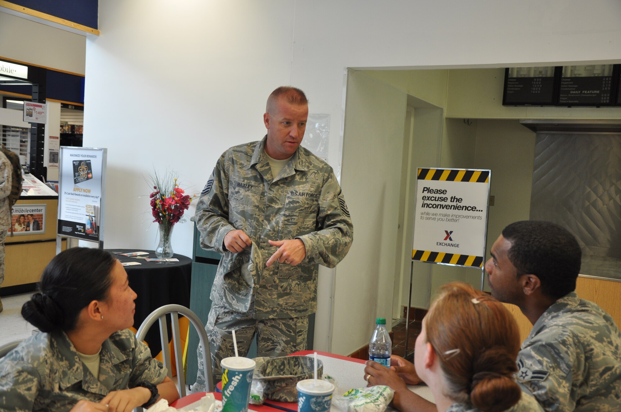 Master Sgt. James Baxley, 17th Medical Group first sergeant, talks to Airman 1st Class Shawn Hall, Airman 1st Class Jasmine Berganio and Airman Elizabeth Campbell, all from the 316th Training Squadron, after giving them $20 AAFES gift cards July 3. Goodfellow first sergeants randomly handed out gift cards totaling $500 to servicemembers. (U.S. Air Force photo/Senior Airman Anne Gathua)