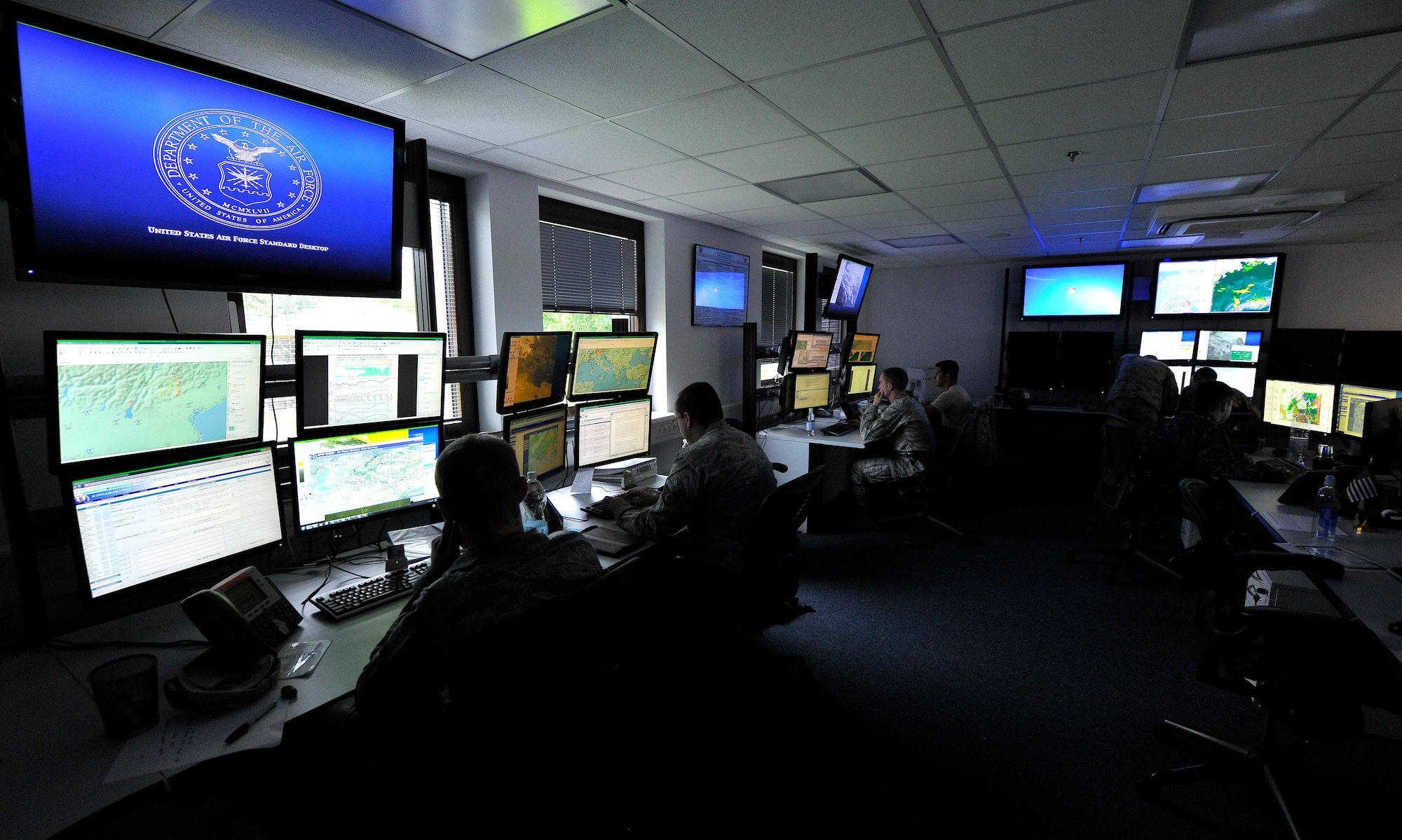 Members of the 21st Operational Weather Squadron review and analyze daily forecast charts on Kapuan Air Station, Germany, July 6, 2012. The 21st Operational Weather Squadron’s mission is to provide commanders and operators with highly accurate, timely and relevant environmental situational awareness in support of U.S. Air Force, Joint and Combined operations across the U.S. European Command and U.S. Africa Command areas of responsibility.  (U.S. Air Force photo/Senior Airman Chris Willis)