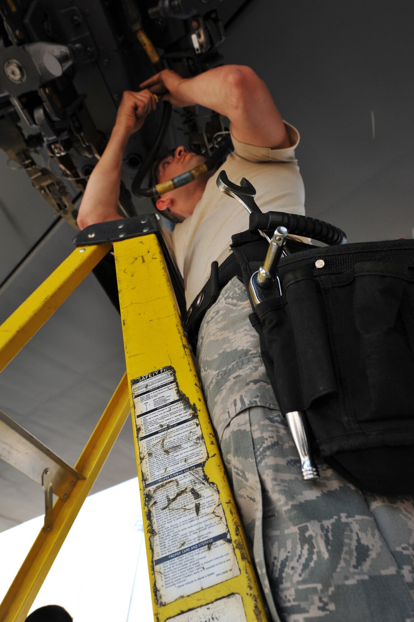 MINOT AIR FORCE BASE, N.D. -- Senior Airman Adam Gonzalez, 5th Aircraft Maintenance Squadron load crew member, performs a bomb rack preparation on a B-52H Stratofortess during a weapons load competition here July 3. Load competitions are used to build unit morale and cohesiveness. (U.S. Air Force photo/Senior Airman Brittany Y. Auld)