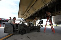 MINOT AIR FORCE BASE, N.D. -- Col. James Dawkins, 5th Bomb Wing commander, used an MJ-1 Jammer to carry a Mark-82 training weapon to the B-52H Stratofortress during a weapons load competition here July 3.  Weapon loading competitions are held quarterly but this is the first time an event such as “Colonels versus Lieutenants” has happened. (U.S. Air Force photo/Senior Airman Brittany Y. Auld)
