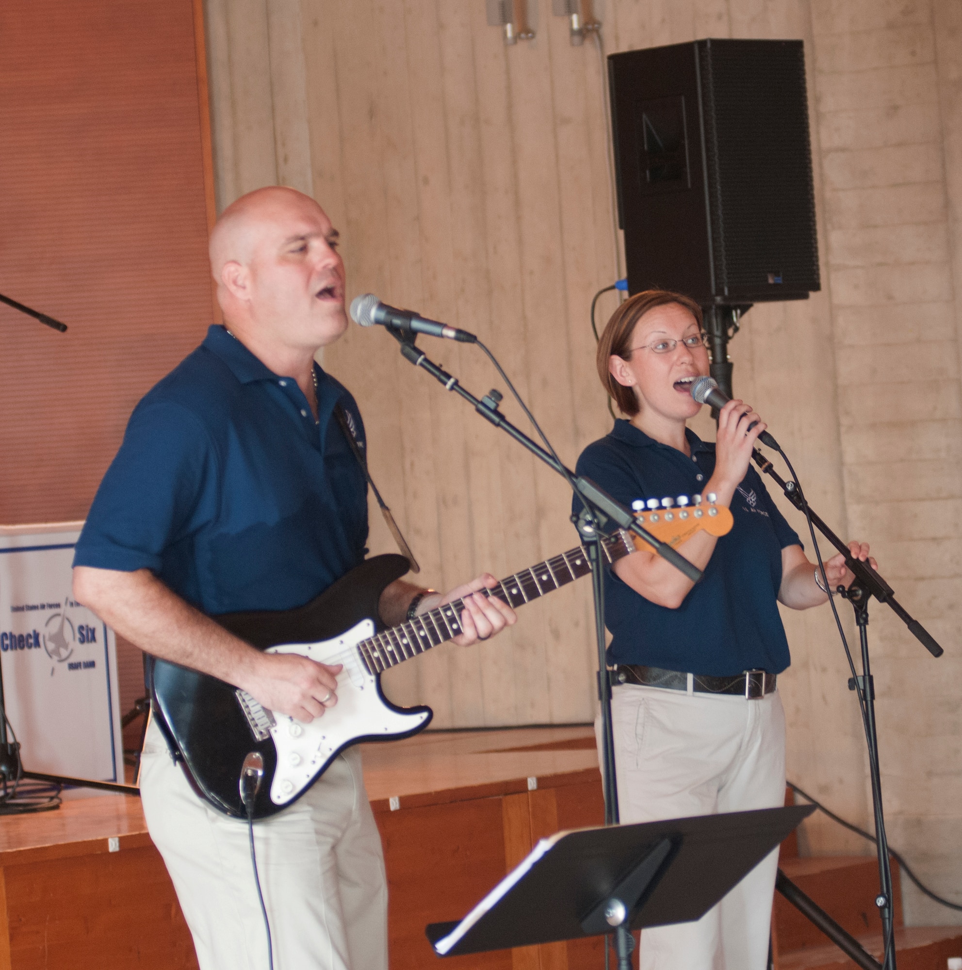 (Left) Staff Sgt’s Jason Cale and Rachel Trimble (Right) perform a song for children attending the Roveredo in Piano music school July 6 at Roveredo, Italy. Cale and Trimble are part of the U.S. Air Forces in Europe band Check Six who performed for aspiring musicians in the local community. (U.S. Air Force photo/Airman 1st Class Briana Jones)