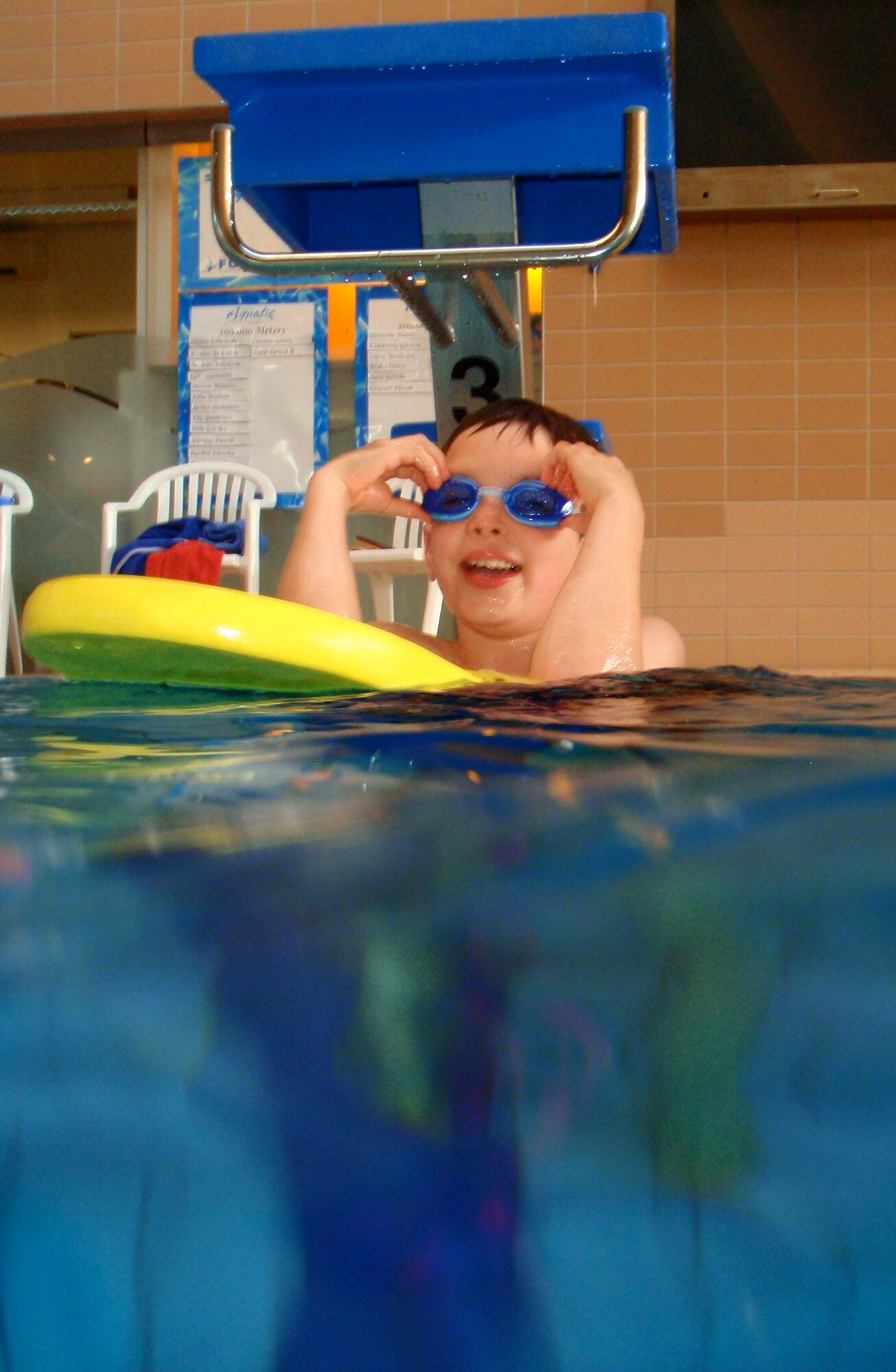 Sean Erickson, son of Master Sgt. David Erickson, 3rd Air Force, listens to his instructor, Ben Blixt, water safety instructor, as he shows the children what their next task is during their swim lesson at the Aquatics Center here June 29. Swim lessons teach children life-long skills of patience, practice, water safety and helps build social skills. (U.S. Air Force photo/Airman 1st Class Hailey Haux)