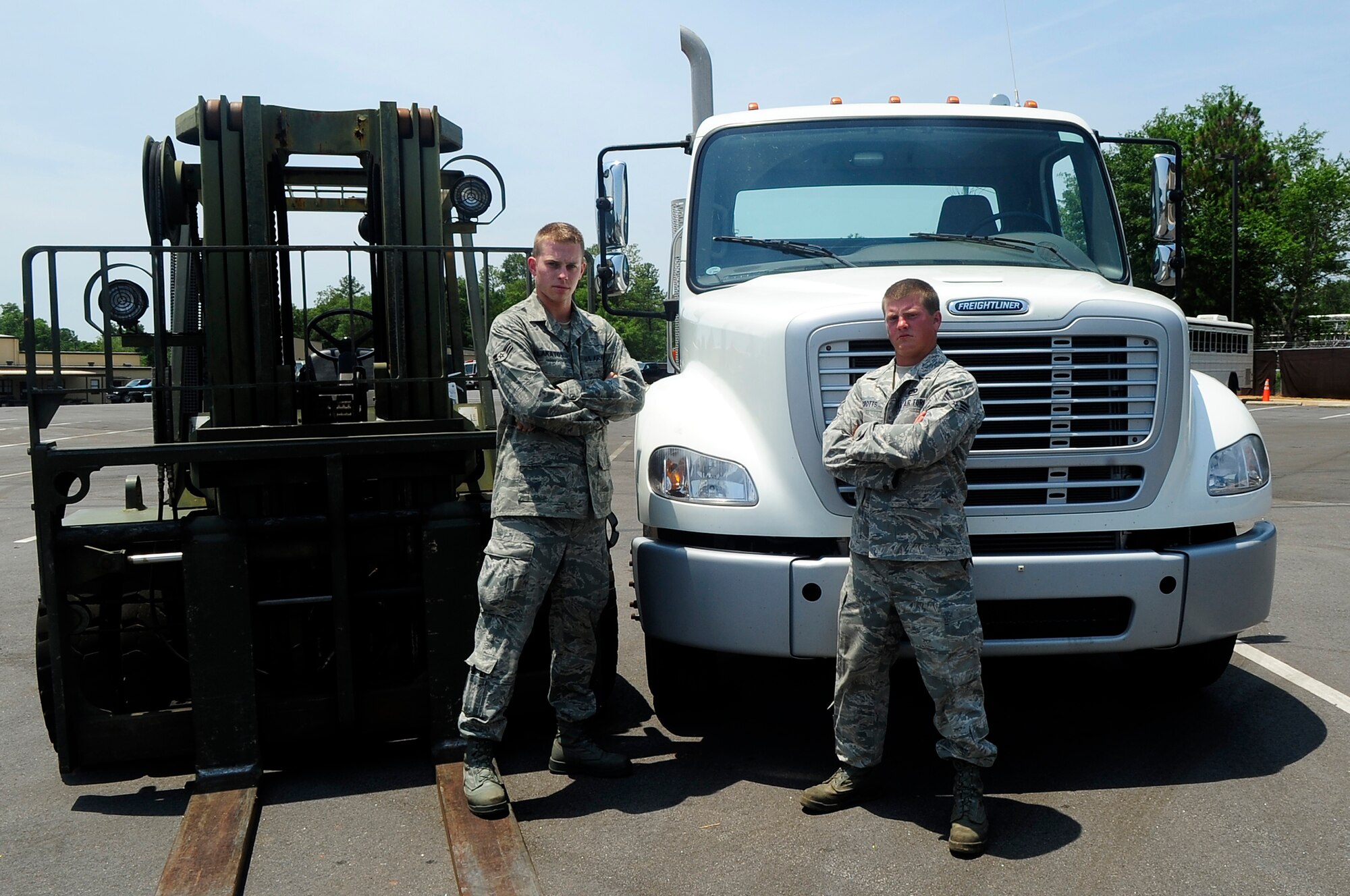 U.S. Air Force Senior Airman Zachary Lakatos and Senior Airman Stewart Crotts, 20th Logistics Readiness Squadron vehicle operators, pose for a photo after being announced the winners of both competitions in the vehicle rodeo at Shaw Air Force Base, S.C., July 6, 2012. The rodeo consisted of two events; a fork-lift and tractor trailer obstacle course. These courses were designed to challenge each Airman both physically and mentally. (U.S. Air Force photo by Airman 1st Class Hunter Brady/Released)