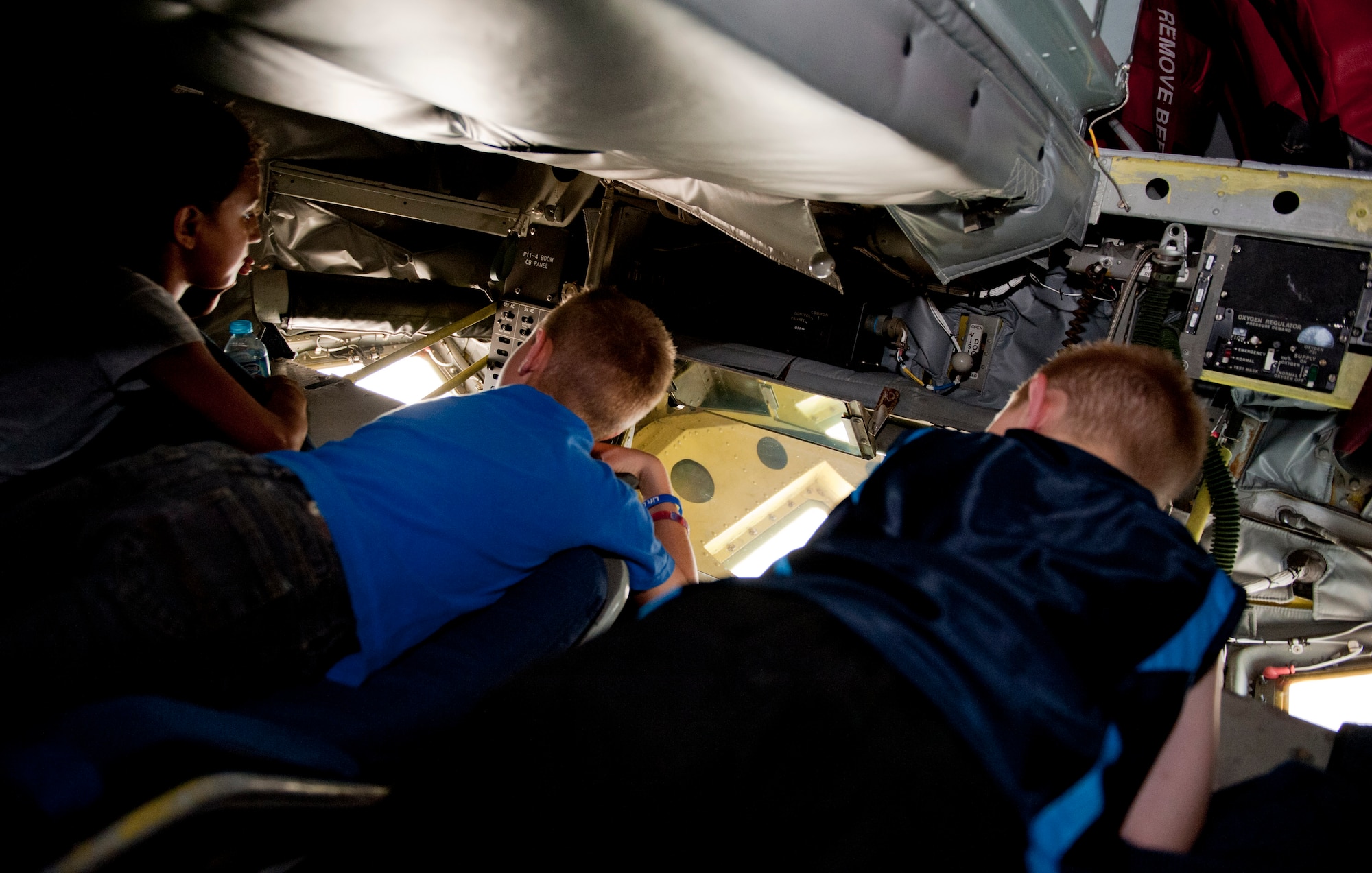 Children of 39th Maintenance Squadron Airmen check out the in-air refueling window on a KC-135 Stratotanker during a squadron tour July 6, 2012, at Incirlik Air Base, Turkey. The KC-135 provides the core aerial refueling capability for the United States Air Force and has held this role for more than 50 years. (U.S. Air Force photo by Senior Airman Anthony Sanchelli/Released)