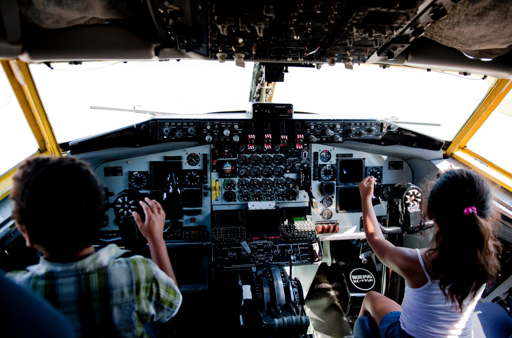 Children of 39th Maintenance Squadron Airmen check out the flight deck on a KC-135 Stratotanker during a squadron tour July 6, 2012, at Incirlik Air Base, Turkey. The KC-135 provides the core aerial refueling capability for the United States Air Force and has held this role for more than 50 years. (U.S. Air Force photo by Senior Airman Anthony Sanchelli/Released)