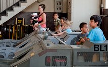 Spouses and children of 39th Maintenance Squadron Airmen playfully inspect an MJ-1B bomb lift during a squadron tour July 6, 2012, at Incirlik Air Base, Turkey. The tour was created for family members and friends of 39th MXS Airmen who wished to see and know more about what their loved one does at work. (U.S. Air Force photo by Senior Airman Anthony Sanchelli/Released)