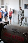 Senior Airman Allen Johnson, 39th Maintenance Squadron electrical and environmental technician, discusses the dangers of liquid oxygen during a squadron tour July 6, 2012, at Incirlik Air Base, Turkey. Liquid oxygen is used when maintainers service aircraft to provide them with breathable oxygen. (U.S. Air Force photo by Senior Airman Anthony Sanchelli/Released)