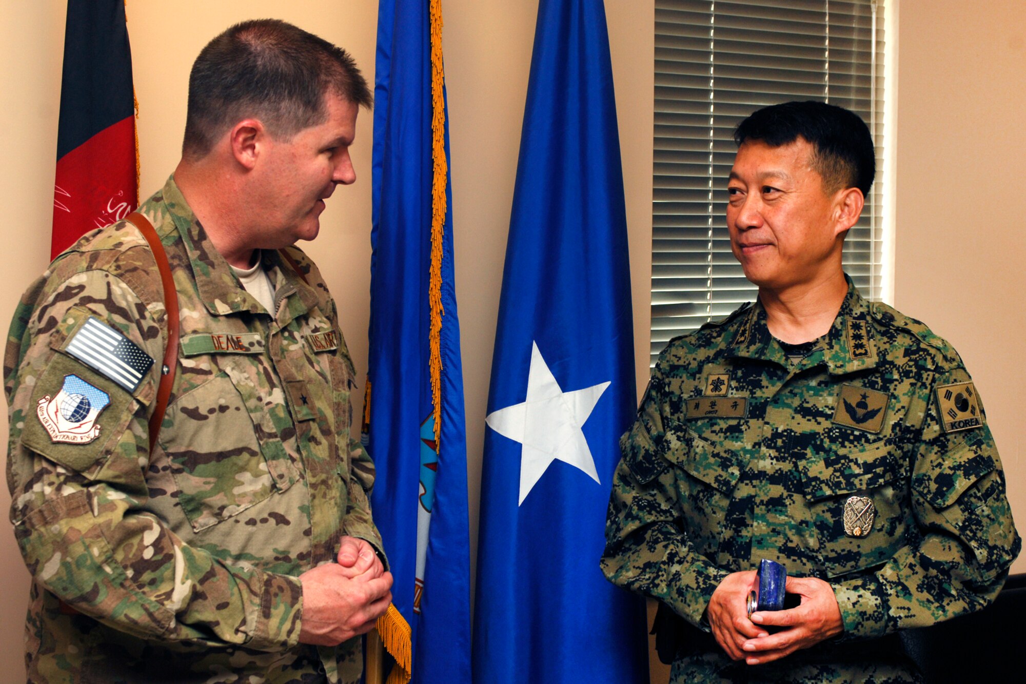Brig. Gen. Thomas Deale, 455th Air Expeditionary Wing commander, speaks with Col. Wankyu Choi, Republic of Korea Provincial Reconstruction Force commander, at Bagram Airfield, Afghanistan, July 9, 2012. Deale was presented the Certificate of Commendation by the Republic of Korea Joint Chiefs of Staff for his devoted support to the ROK Provincial Reconstruction Team and for his contributions in helping to strengthen the alliance between ROK and the United States here at BAF. (U.S. Air Force photo/Staff Sgt. Jeff Nevison)