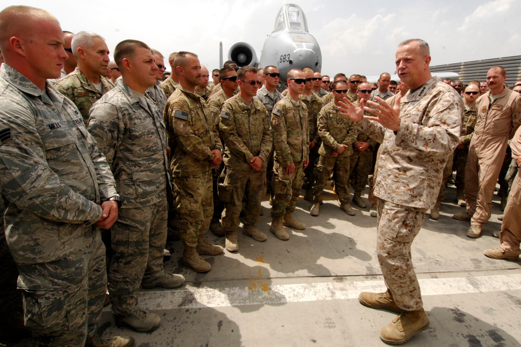 Airmen from the 104th Expeditionary Fighter Squadron listen as Marine Corps Gen. John Allen, International Security Assistance Force commander, congratulates them on a job well done during his visit to Bagram Airfield, Afghanistan, July 8, 2012. The general stopped through Bagram to speak to 104 EFS and to “coin” some members of the squadron for their outstanding performances before they redeploy home. (U.S. Air Force photo/Staff Sgt. Jeff Nevison)