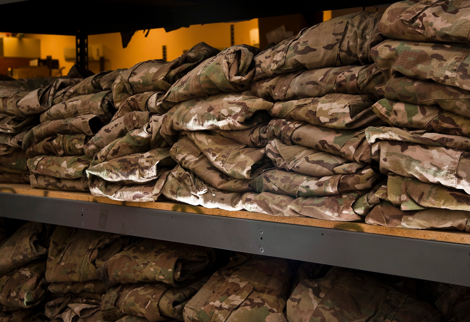 Stacks of recycled Operation Enduring Freedom Camouflage Pattern uniforms await Airmen at Bagram Airfield, Afghanistan, July 7, 2012. The uniform has become the iconic attire of coalition forces in Afghanistan for many reasons. They’re lightweight, flame retardant, and well suited to blend with Afghanistan’s terrain. (U.S. Air Force photo/Capt. Raymond Geoffroy)