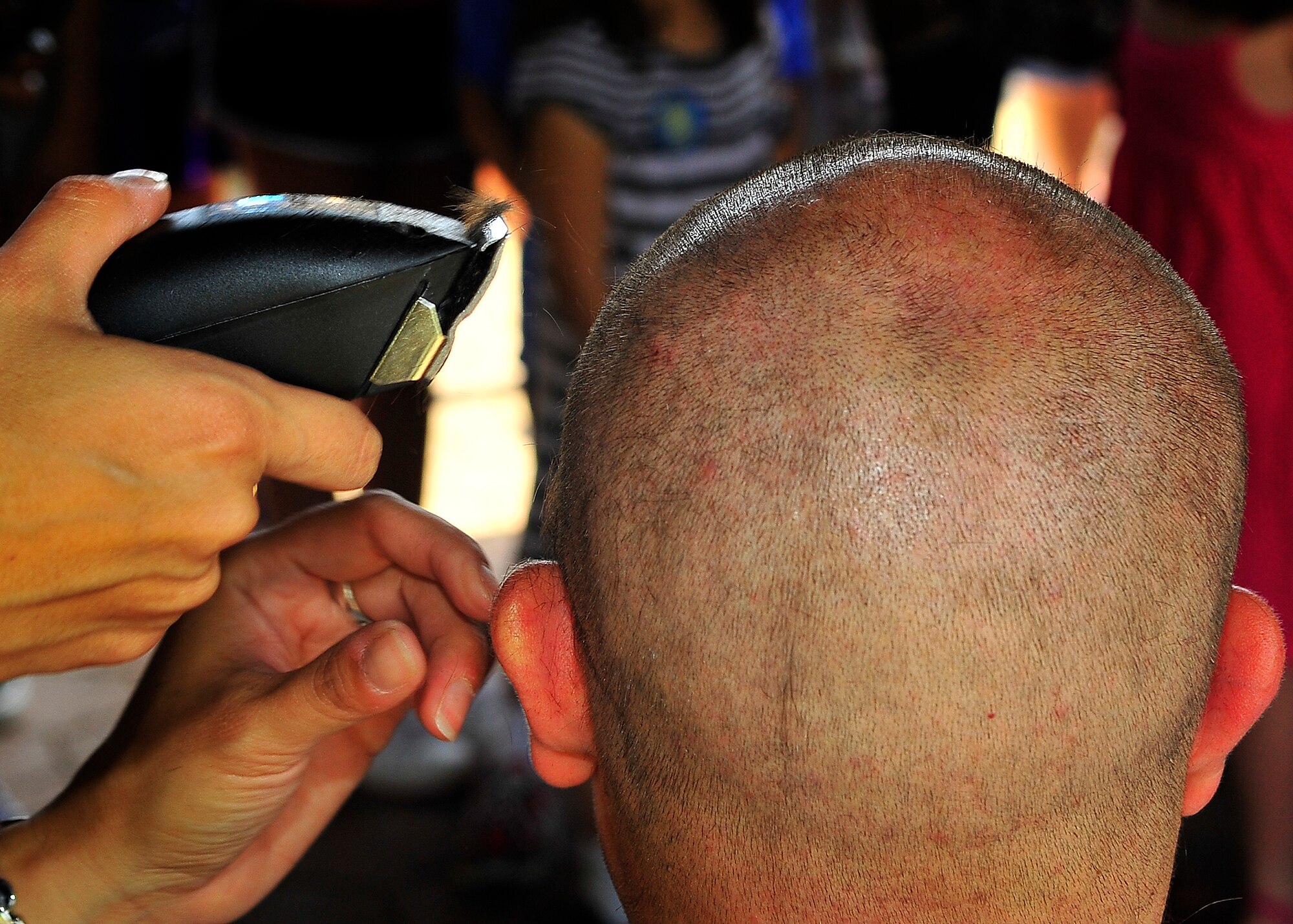 St. Baldrick's Foundation held the third-annual "Shave your head for childhood cancer" event at Donnelly Park on Ramstein Air Base, Germany, June 30, 2012.  More than 80 men and women shaved their heads during the event, generating over $18,000 in donations, surpassing the goal of $15,000. (U.S. Air Force photo/Staff Sgt. Daylena Gonzalez)

