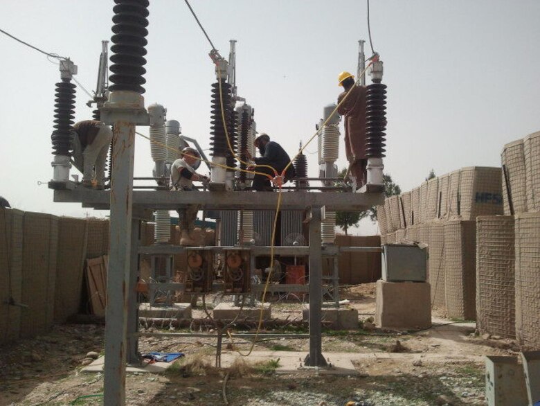 AFGHANISTAN — Afghan and U.S Army Corps of Engineers engineers and electricians clean, repair and service the 110kV main disconnect switch assembly at the Sangin Substation in Helmand province, Afghanistan. The Sangin substation will be repaired under a USACE-awarded contract to improve transmission lines and substations in the Helmand province.