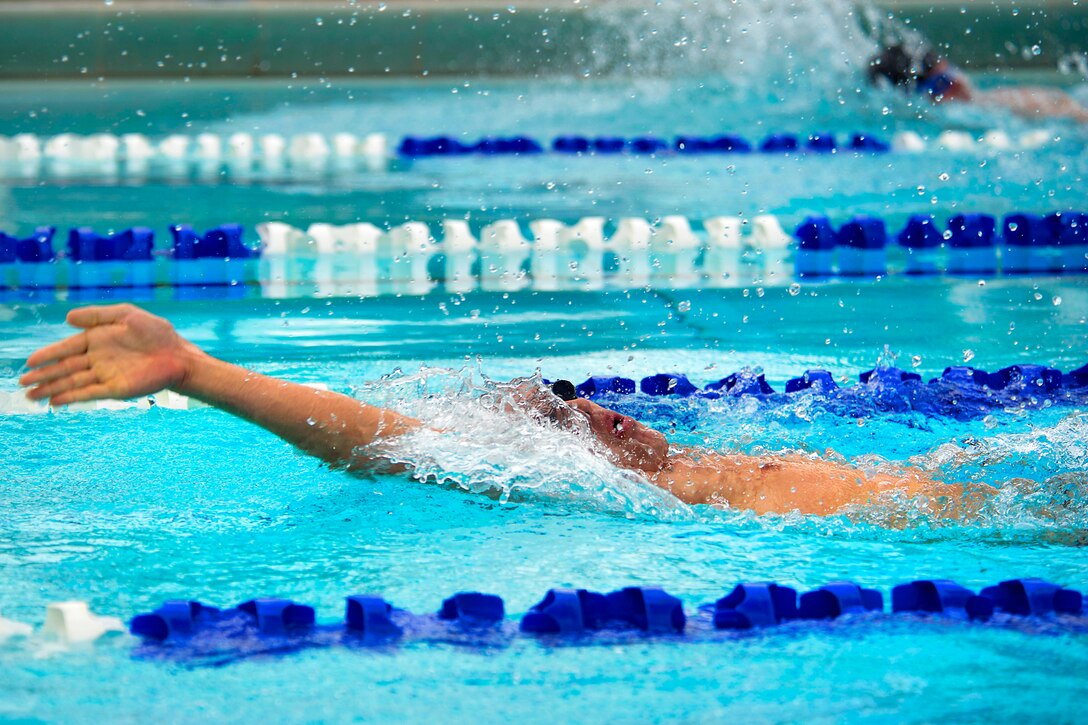 A Royal New Zealand sailor swims the 50-meter backstroke during a Rim ...