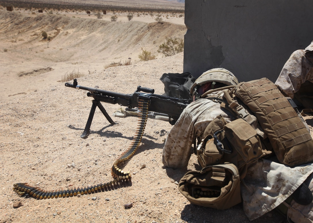 A military policeman fires an M249B machine gun during a crew-served weapons shoot for Large Scale Exercise-1, Javelin Thrust 2012 on Marine Corps Air Ground Combat Center Twentynine Palms, Calif., July 8, 2012. 