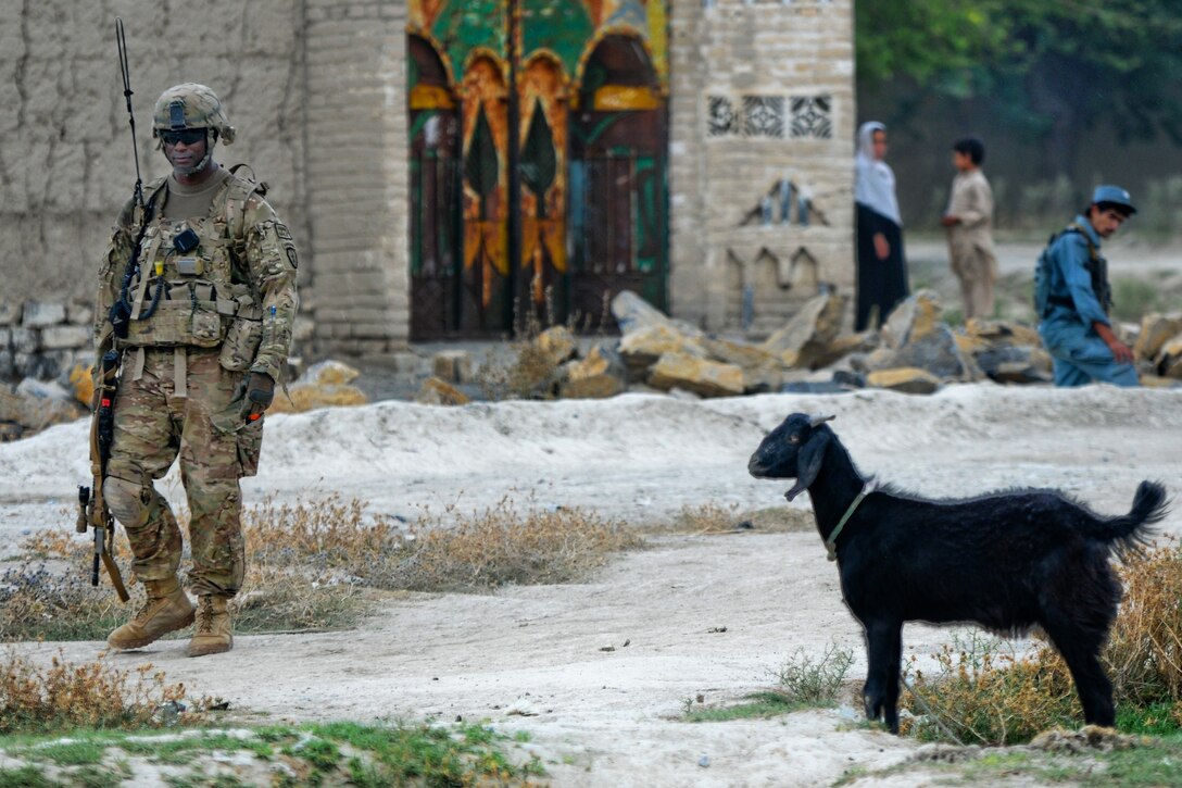 U.S. Army Sgt. 1st Class Marlon Green pulls security in front of a doctors' qalat in the village of Kunday in Afghanistan's Khowst province, July 7, 2012. Green, a platoon sergeant, is assigned to the 2nd Battalion (Airborne), 377th Field Artillery Regiment. 