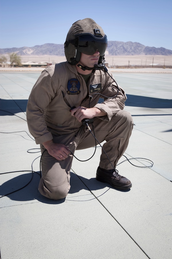 MARINE CORPS AIR GROUND COMBAT CENTER TWENTYNINE PALMS, Calif. - Sgt. Robert Brensinger, a crew chief with Marine Heavy Helicopter Squadron 772, engages the fuel valves during a refuel for an AH-1W Super Cobra attack helicopter at the Strategic Expeditionary Landing Field here July 9 during Exercise Javelin Thrust 2012. Javelin Thrust is an annual large scale exercise which allows active and reserve Marines and Sailors from 38 different states to train together as a seamless Marine Air Ground Task Force. (Official U.S. Marine Corps photo by Sgt. John M. Odette/Released)