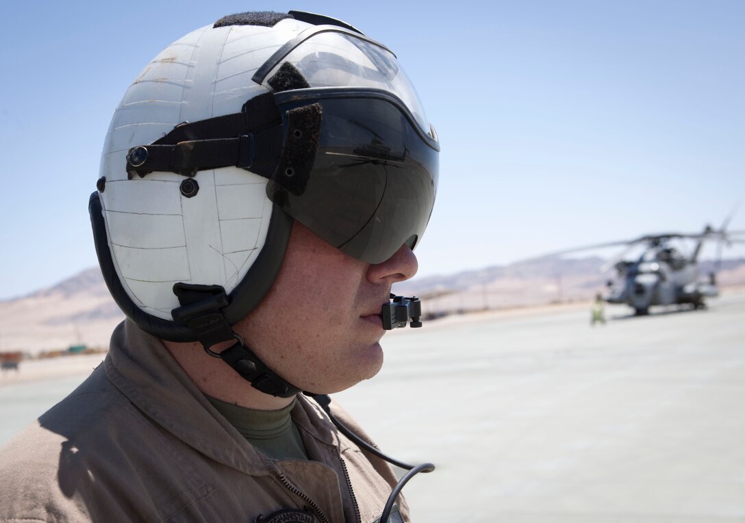 MARINE CORPS AIR GROUND COMBAT CENTER TWENTYNINE PALMS, Calif. - Sgt. Greg Farren, a crew chief with Marine Heavy Helicopter Squadron 772, monitors the fuel hose connectivity during a refuel for an AH-1W Super Cobra attack helicopter at the Strategic Expeditionary Landing Field here July 9 during Exercise Javelin Thrust 2012. Javelin Thrust 2012 is an annual large scale exercise at Marine Corps Air Ground Combat Center Twentynine Palms, Calif., which allows active and reserve Marines and Sailors from 38 different states to train together as a seamless Marine Air Ground Task Force. (Official U.S. Marine Corps photo by Sgt. John M. Odette/Released)