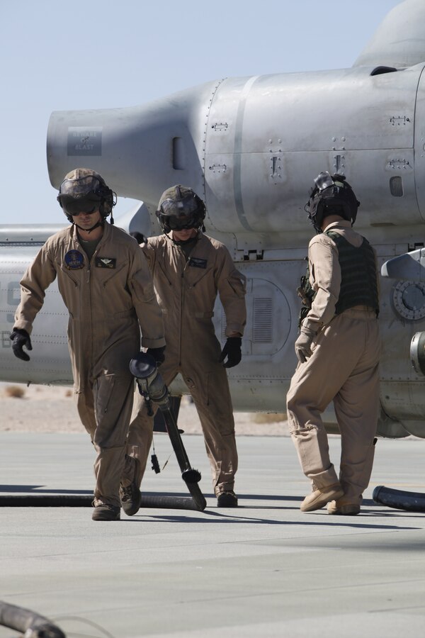 MARINE CORPS AIR GROUND COMBAT CENTER TWENTYNINE PALMS, Calif. - Staff Sgt. David Scranton and Sgt. Robert Brensinger pull the refueling hose back to their CH-53E cargo helicopter after refueling an AH-1W Super Cobra attack helicopter at the Strategic Expeditionary Landing Field here July 9 during Exercise Javelin Thrust 2012. Javelin Thrust is an annual large-scale exercise which allows active and reserve Marines and sailors from 38 different states to train together as a seamless Marine Air Ground Task Force. (photo by Master Sgt. Chris W. Cox)