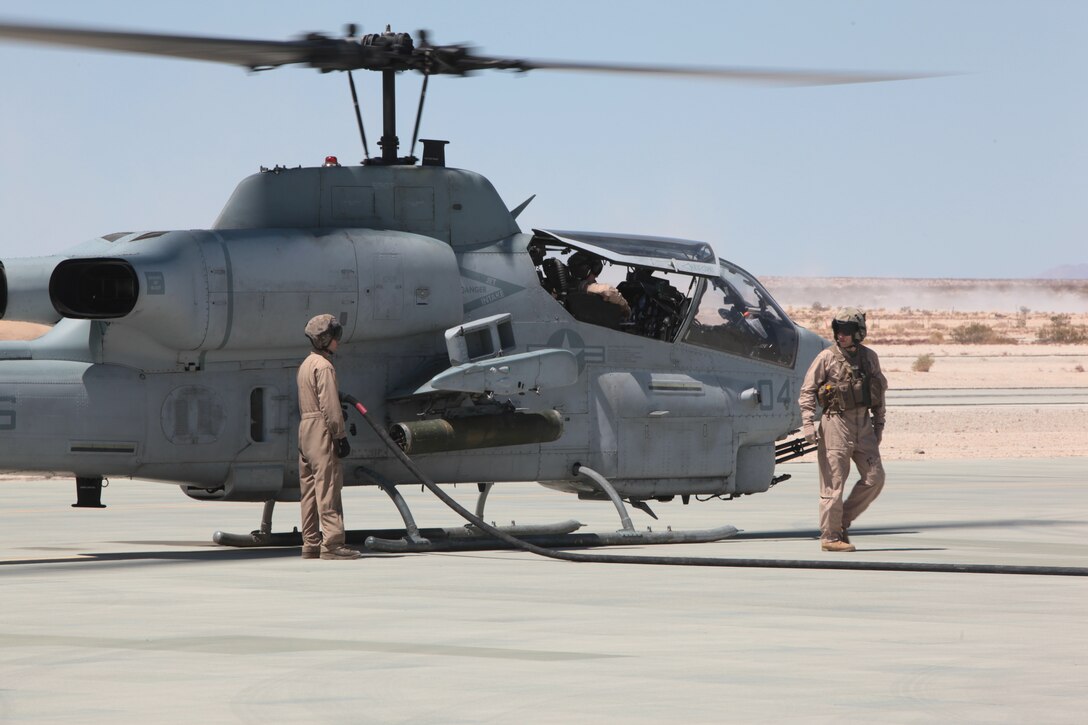 MARINE CORPS AIR GROUND COMBAT CENTER TWENTYNINE PALMS, Calif. - Marines from Marine Heavy Helicopter Squadron 772 refuel an AH-1W Super Cobra helicopter during Exercise Javelin Thrust 2012. Javelin Thrust is an annual large-scale exercise which allows active and reserve Marines and Sailors from 38 different states to train together as a seamless Marine Air Ground Task Force. (Photo by Sgt. Kevin M. Okamura/Released)