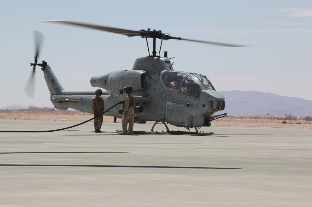 MARINE CORPS AIR GROUND COMBAT CENTER TWENTYNINE PALMS, Calif. - Marines from Marine Heavy Helicopter Squadron 772 refuel an AH-1W Super Cobra helicopter at thye Strategic Expeditionary Landing Field here during Exercise Javelin Thrust  2012. Javelin Thrust 2012 is an annual large-scale exercise which allows Active and Reserve Marines and Sailors from 38 different states to train together as a seamless Marine Air Ground Task Force. (Photo by Sergeant Kevin M. Okamura/Released)