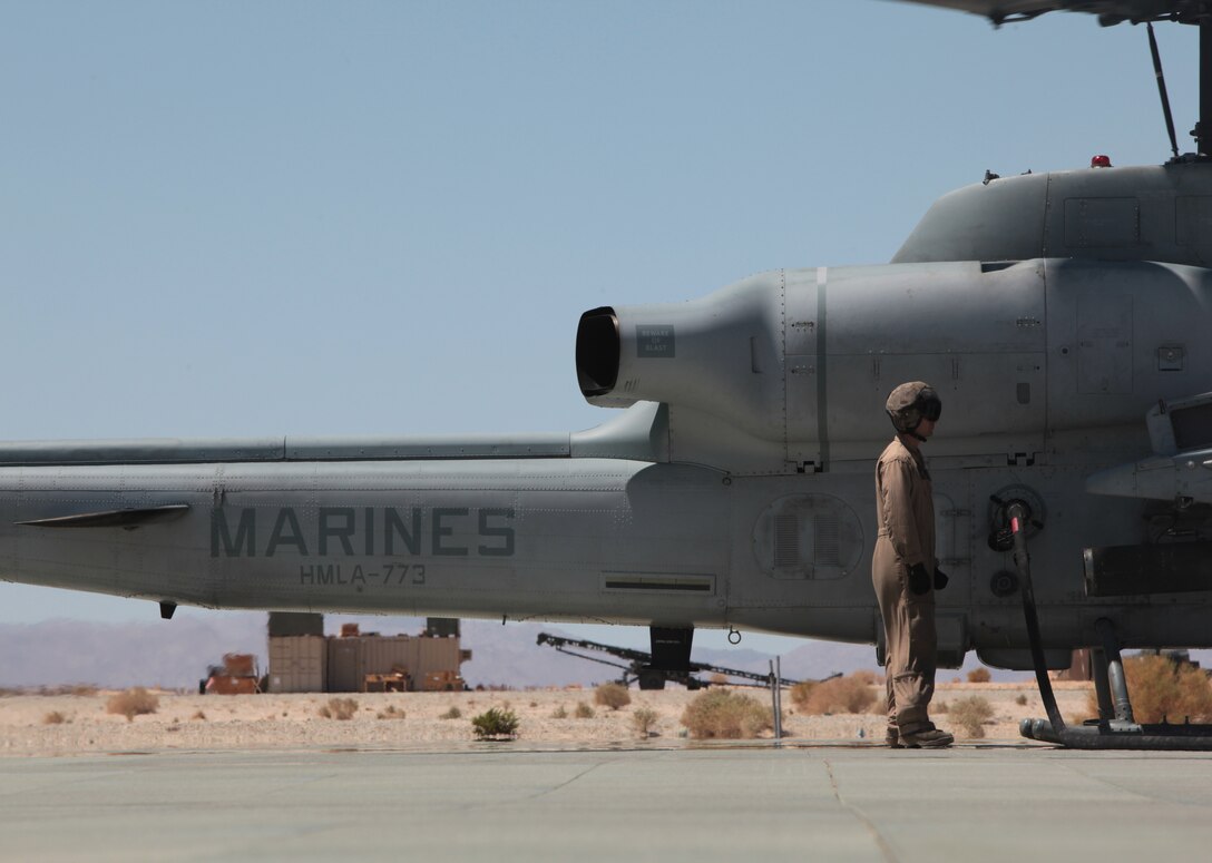 MARINE AIR GROUND COMBAT CENTER TWENTYNINE PALMS, Calif. - Marines from Marine Heavy Helicopter Squadron 772 refuel an AH-1W Super Cobra helicopter during exercise  Javelin Thrust  2012. Javelin Thrust is an annual large-scale exercise which allows active and reserve Marines and Sailors from 38 different states to train together as a seamless Marine Air Ground Task Force. (Photo by Sergeant Kevin M. Okamura/Released)