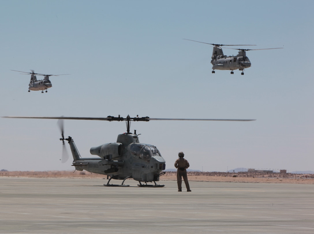 MARINE CORPS AIR GROUND COMBAT CENTER TWENTYNINE PALMS, Calif. - Cpl. Kevin McClernon from Marine Heavy Helicopter Squadron prepares a AH-1W Super Cobra helicopter to taxi after refueling at the Strategic Expeditionary Landing Field here during exercise  Javelin Thrust  2012. Javelin Thrust is an annual large-scale exercise which allows active and reserve Marines and Sailors from 38 different states to train together as a seamless Marine Air Ground Task Force. (Photo by Sergeant Kevin M. Okamura/Released)