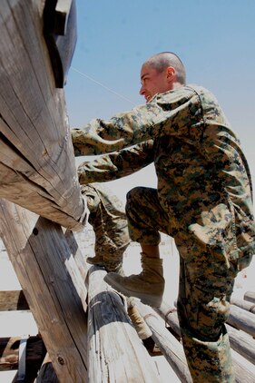 Recruits climb the log ladder portion of the "A" frame obstacle during Confidence Course II June 26 aboard Marine Corps Recruit Depot San Diego. Confidence Course II allows recruits to run through the whole course and challenge the higher obstacles to overcome the fear of heights and gain confidence about their accomplishments. 
