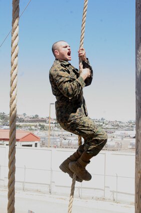 A recruit war cries as he slides down the 30-foot rope to the ground below on the "A" frame obstacle during Confidence Course II June 26 aboard Marine Corps Recruit Depot San Diego. The high obstalce portion of the Confidence Course allows recruits to build physical and mental strength to overcome any fears and obstalce.