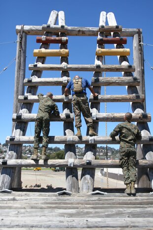 Recruits climb the log ladder portion of the "A" frame obstacle to slide down a 30-foot rope during Confidence Course II June 26 aboard Marine Corps Recruit Depot San Diego. Confidence Course II allows recruits to run through the whole course and challenge the higher obstacles to overcome the fear of heights and gain confidence about their accomplishments.