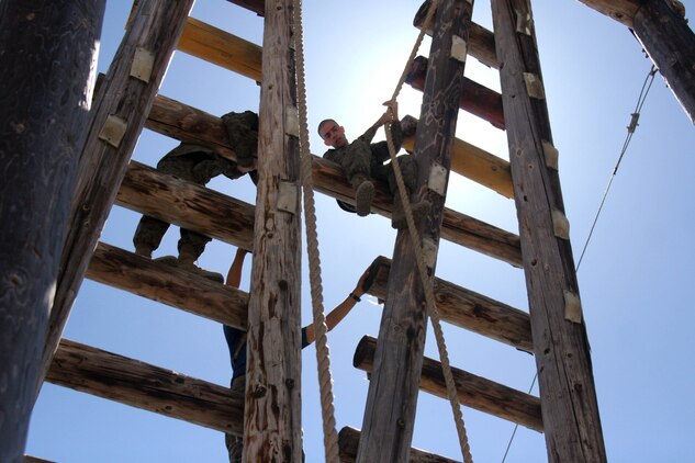 A recruit grabs hold of a rope before sliding down the "A" frame during Confidence Course II June 26 aboard Marine Corps Recruit Depot San Diego. The "A" frame is an obstacle that requires recruits to use physical and mental strength to overcome any fear of heights.