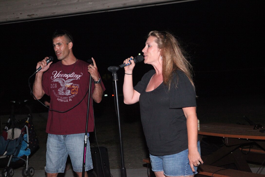 Chief Warrant Officer 2 Tevis Lang, the officer in charge with analysis method group, 2nd Intelligence Battalion, and his wife Angie sang karaoke during the Flashback Fridays classic rock-theme event hosted by Marine Corps Community Services at Onslow Beach aboard Marine Corps Base Camp Lejeune July 6. The disc jockey played classic rock from the 50s up to the 90s. 